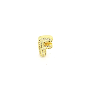 Detailed view of a gold-plated letter F pendant encrusted with sparkling white zircons