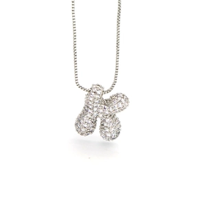 Detailed macro view of the silver-tone cubic zirconia pave capital letter K pendant necklace