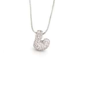 Macro shot of silver letter J pendant with micro-pave cubic zirconia on a fine box chain