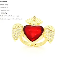 Detail view of heart ring with gold wings, white zircons and adjustable band