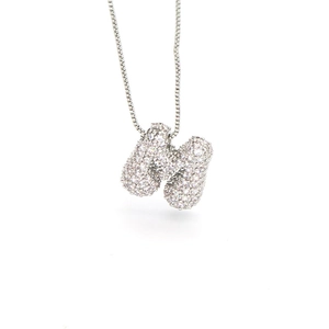 Macro shot of silver-tone letter H pendant with pavé cubic zirconia on box chain