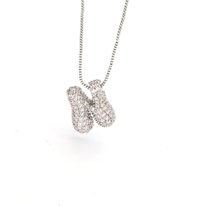 Macro detail of silver-colored letter N pendant with micro-paved cubic zirconia stones