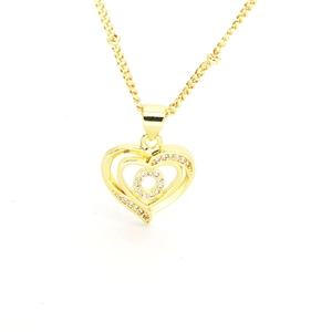 Macro detail of 18k gold plated heart pendant with sparkling crystals and fine chain link
