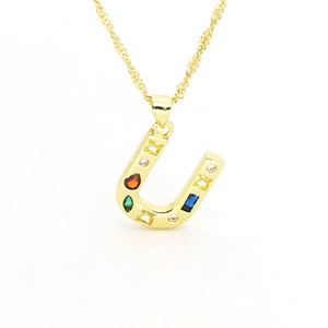 Detail of a golden horseshoe pendant necklace with colorful multi-colored gemstones