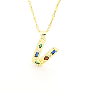 Detail shot of golden V-letter pendant with vibrant multi-color zircon stone settings