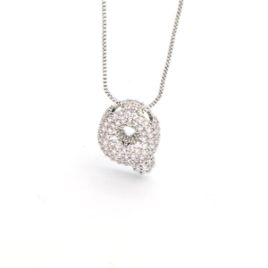 Macro shot of silver letter Q pendant with cubic zirconia on a dainty box chain