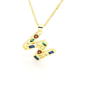 Detail of gold-plated twisted rope chain necklace with colorful zircon letter W pendant