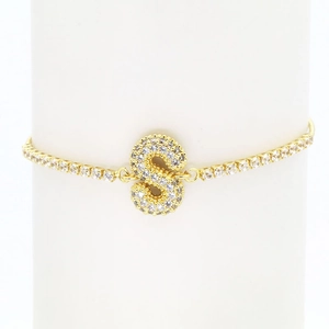Detailed close-up of 18k gold plated tennis bracelet with sparkling pave zircon letter S