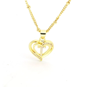 Detailed view of 18k gold heart pendant featuring a sparkling zircon-studded letter T