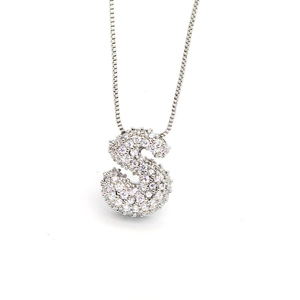 Detailed close-up of puffy S-letter pendant necklace with white zircon pavé setting