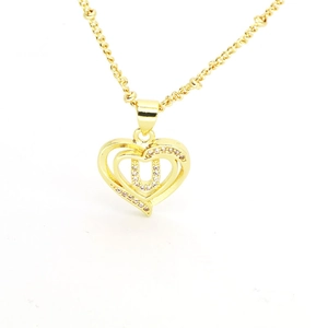 Detail view of 18k gold plated heart pendant with zircon letter U for necklace
