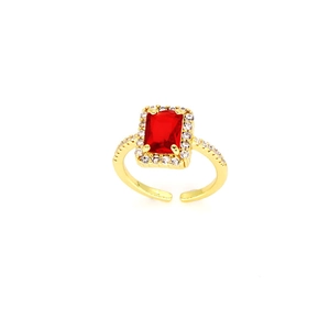 Detail of a vintage gold-plated ring with a rectangular red gemstone and halo setting