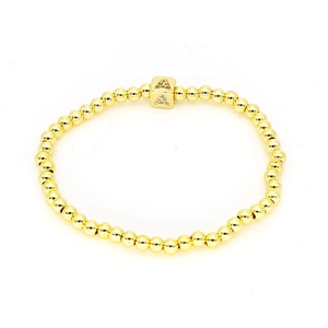 Stretcharmband aus goldenen Perlen mit quadratischem 18k Goldwürfel und Kristall Buchstabe A