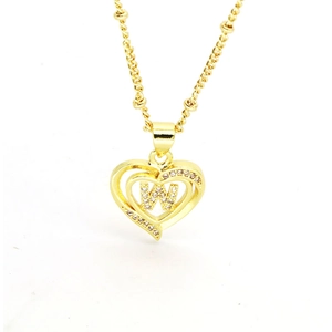Macro detail of 18k gold heart pendant with letter W and sparkling cubic zirconia stones