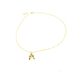 Macro detail of gold letter A pendant necklace featuring colorful zircon stones inlay