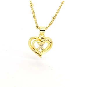 Detailed macro view of 18k gold heart necklace with white zircon pavé and layered design