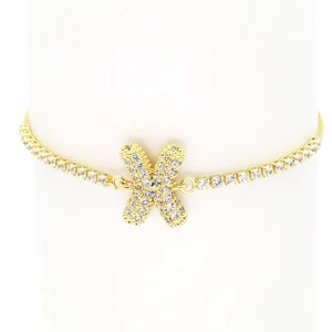 Detailed macro view of 18k gold plated tennis bracelet featuring a micro-pave zircon X charm