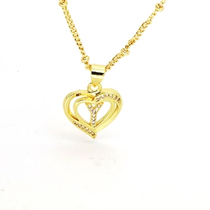 Close-up of 18k gold plated hollow heart pendant with white zircon crystals