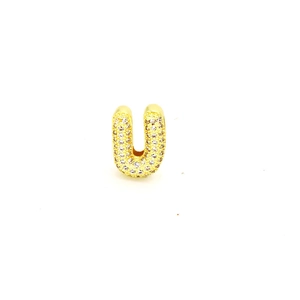 Close-up of gold-plated letter U pendant with sparkling pavé cubic zirconia inlay