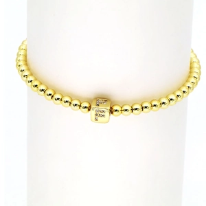 Detailansicht des 18k vergoldeten Perlenarmbandes mit Strass besetztem F-Würfel-Anhänger