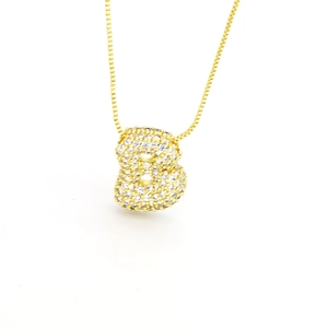 Golden bubble letter B necklace pendant with zircon stones on a white background