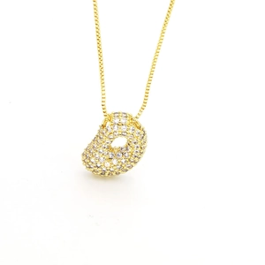 Close-up of gold balloon initial pendant with shimmering cubic zirconia pavé stones