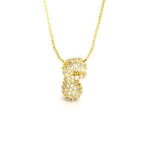 Detailed close-up of a gold peanut pendant with white zircon pavé on a box chain