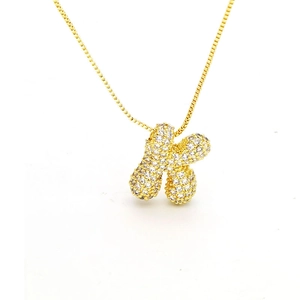 Detailed close-up of gold bubble letter K pendant set with shimmering zircon stones