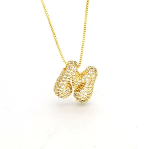 Macro shot of gold-plated 'H' letter pendant with sparkling pavé cubic zirconia