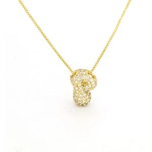 Detail of a golden leopard head pendant necklace encrusted with white cubic zirconia crystals