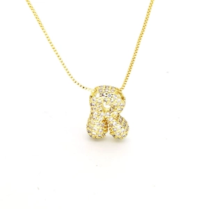 Detail view of gold letter R pendant necklace with paved cubic zirconia stones
