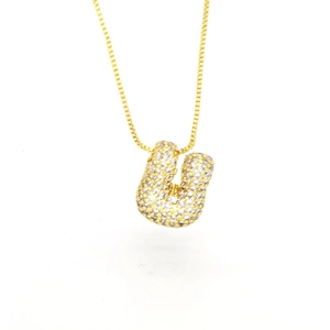 Macro shot of 3D balloon-style letter U pendant with cubic zirconia on gold box chain