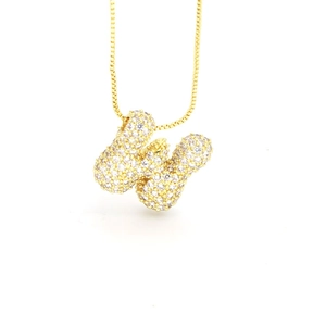 Close-up of golden box chain with a silver butterfly pendant paved with micro zircons