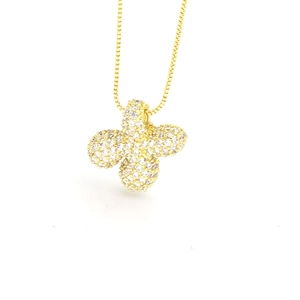 Macro detail of gold four-leaf clover pendant with white zircon pavé setting on box chain