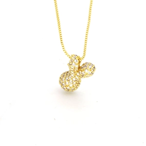 Macro shot of gold box chain necklace with a small zircon-paved balloon letter pendant