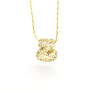 Detailed close-up of a gold money bag pendant with micro-paved sparkling cubic zirconia