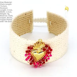Detail of handmade woven sacred heart bracelet with red seed beads and gold finish