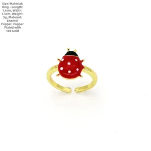 Detail view of the 18k gold plated ladybug ring featuring red enamel and zircon stones