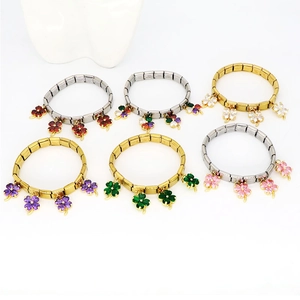 Detailed macro view of stainless steel modular bracelets with colorful clover pendants