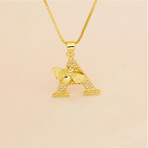 Macro detail of gold letter A pendant with pave zircons and a small 3D bee accent