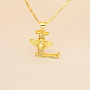 Macro detail of gold letter L pendant with pavé crystals and a 3D bee design on a fine chain