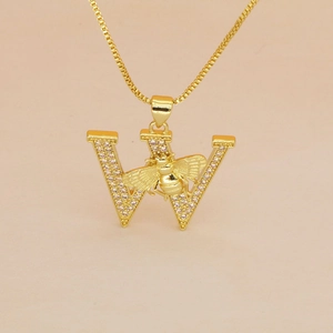 Macro detail of gold letter W pendant with micro-pave crystals and a central 3D honey bee