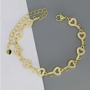 Detail of gold heart chain bracelet with white zircons and adjustable lobster clasp