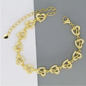 Detail of gold-plated hollow heart bracelet with white zircons and adjustable lobster clasp