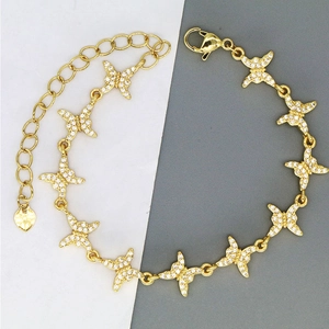 Elegant gold butterfly bracelet with pavé zircon stones and a heart charm for women