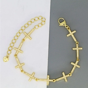 Golden cross link bracelet with white zircon stones and adjustable heart charm chain