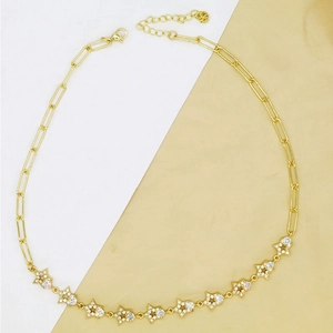 Detail of gold star necklace with paperclip chain and shimmering zircon insets