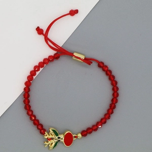 Detail von rotem Kristallperlenarmband mit verstellbarem goldenem Rentieranhänger für Weihnachten