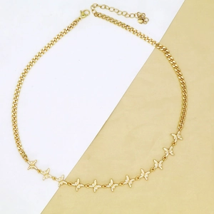 Close-up of gold cuban chain necklace with ten sparkling butterfly charms and lobster clasp