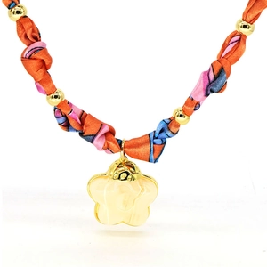 Detailed view of yellow flower pendant with silk scarf chain and golden beads necklace